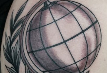 black and grey traditional style globe tattoo