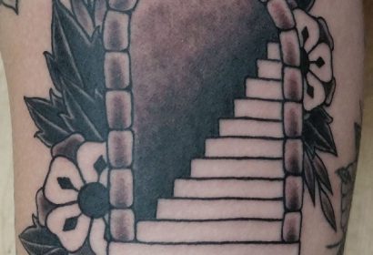 black and grey traditional style staircase tattoo