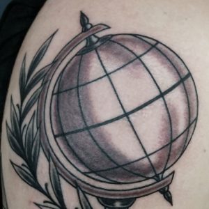 black and grey traditional style globe tattoo