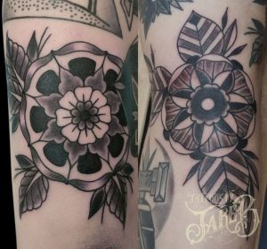 black and grey traditional style Pinwheel flower tattoo