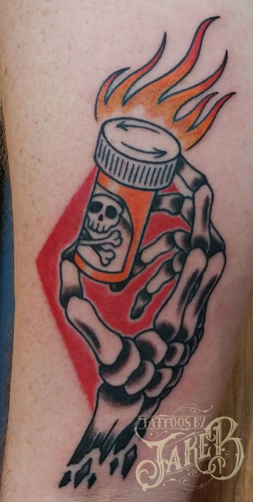 traditional addiction pill hand tattoo