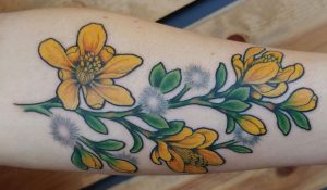 yellow flowers creosote tattoo featured image
