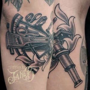 black and grey traditional style sextant tattoo
