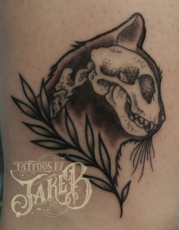 black and grey traditional style cat head tattoo