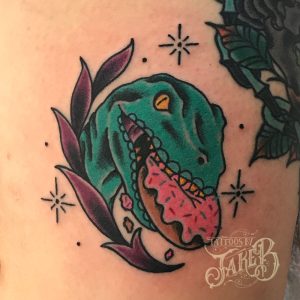 Traditional style dino donut tattoo by Jake B