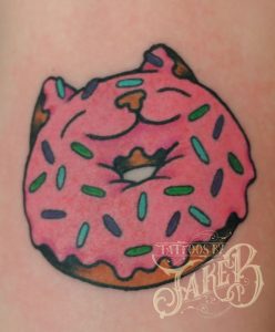 Traditional style cat donut tattoo by Jake B