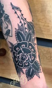 black and grey eye rose tattoo