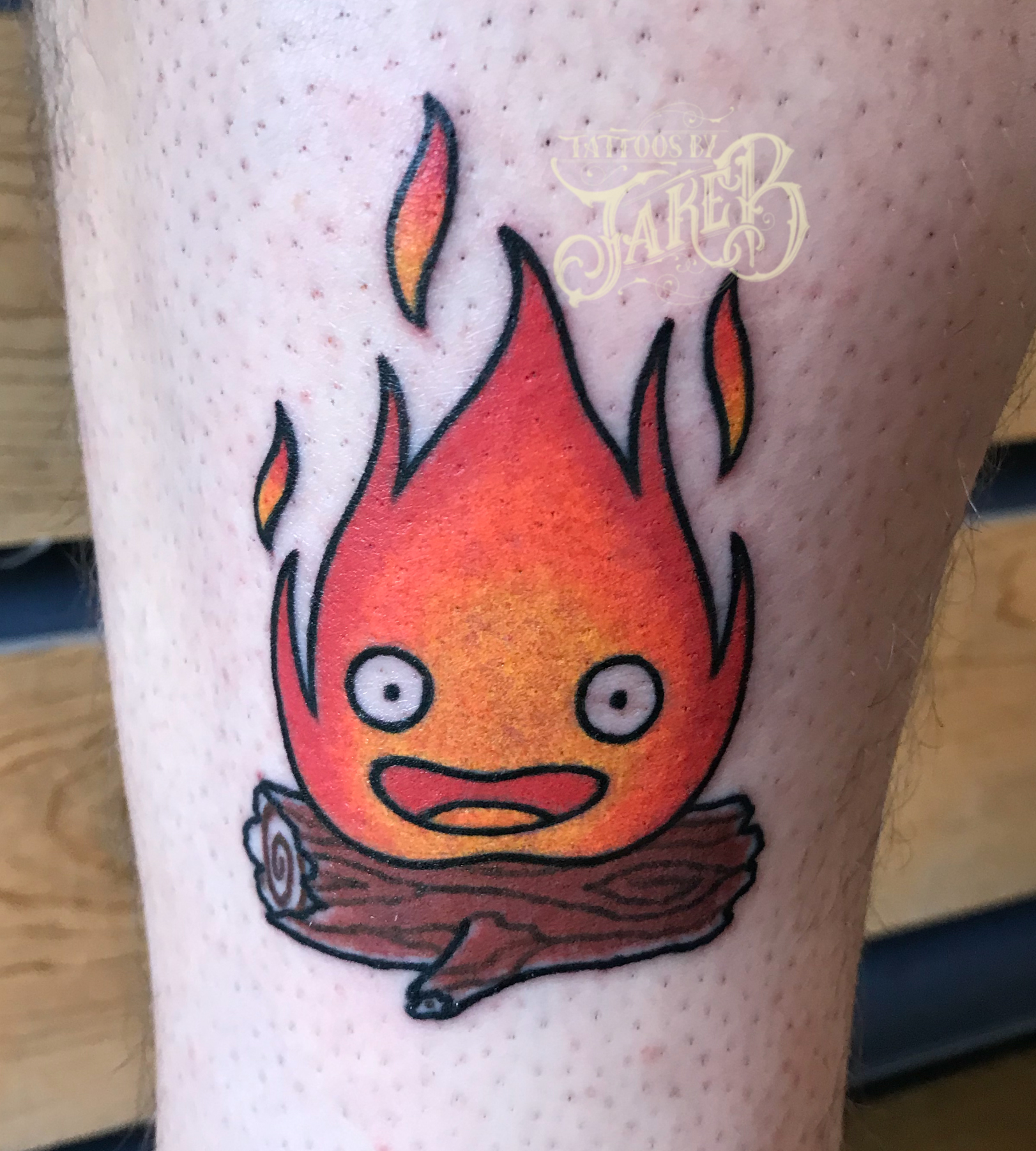 Calcifer tattoo on the left bicep