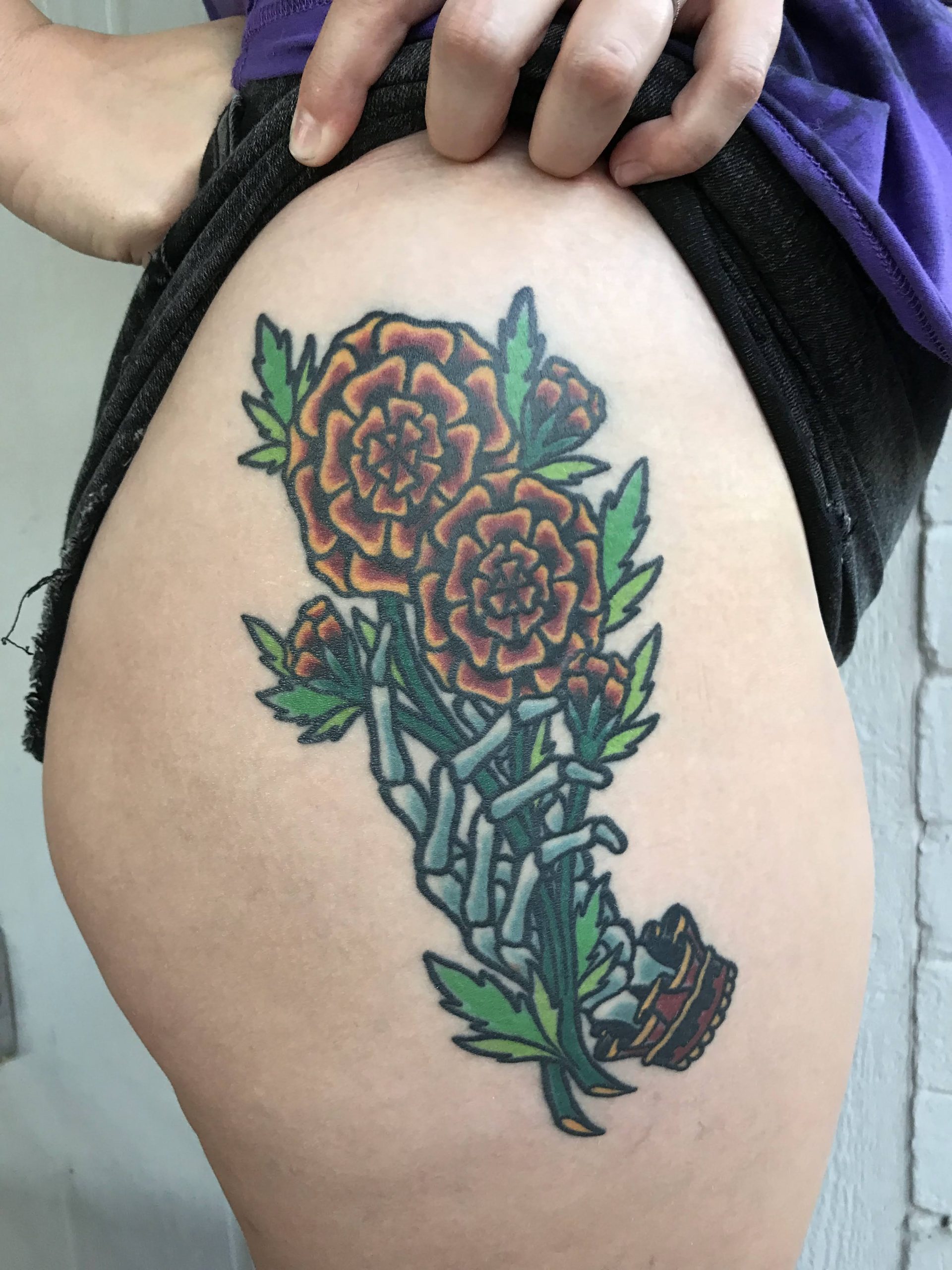 marigolds skeleton hand tattoo by Jake B
